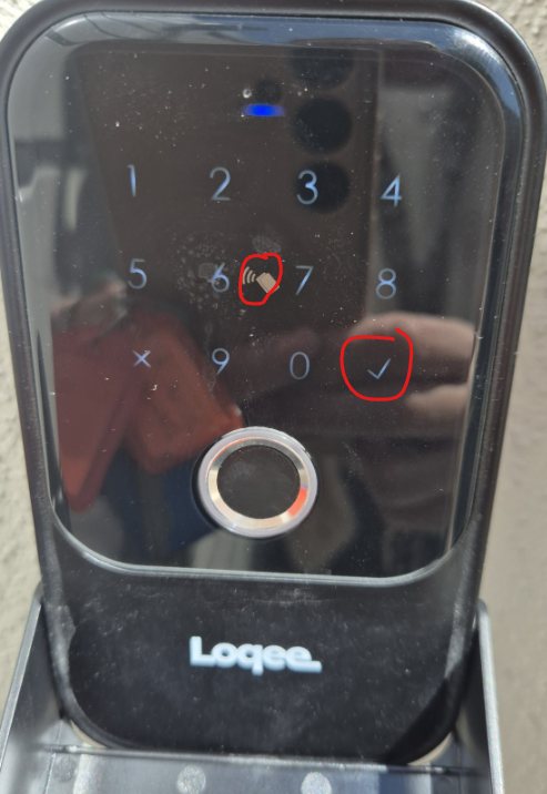 The lockbox keypad, with the first digit and the tick button circled