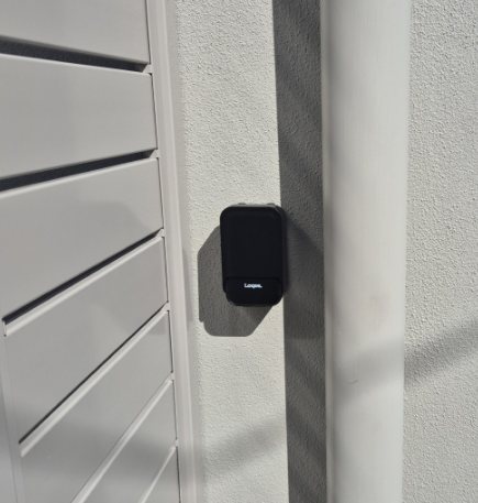 The lockbox mounted on the wall beside the garage